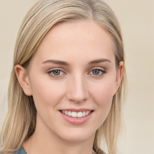 Joyful white young-adult female with long  brown hair and blue eyes