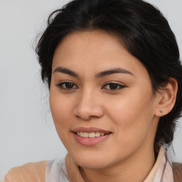 Joyful latino young-adult female with medium  brown hair and brown eyes