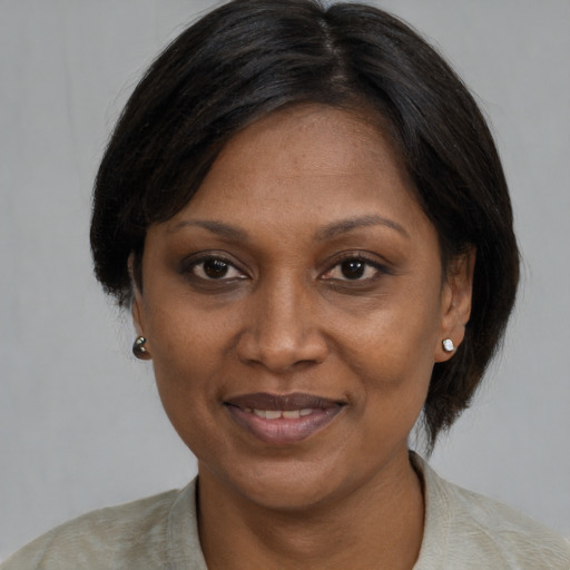 Joyful latino adult female with medium  black hair and brown eyes