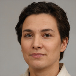 Joyful white adult female with medium  brown hair and brown eyes