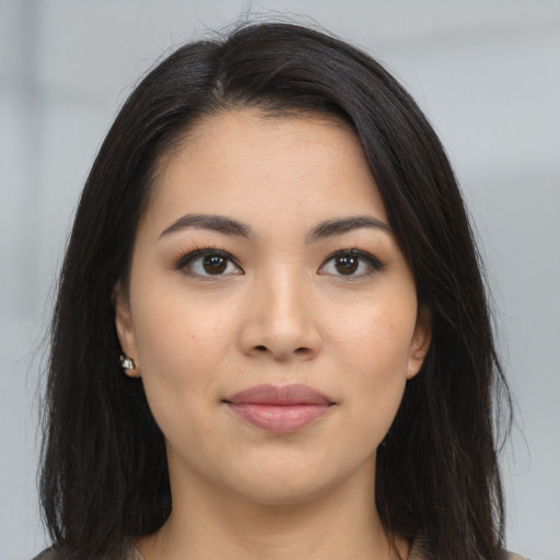 Joyful asian young-adult female with long  brown hair and brown eyes