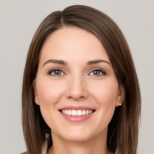 Joyful white young-adult female with long  brown hair and grey eyes