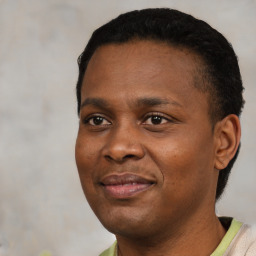 Joyful black young-adult male with short  black hair and brown eyes