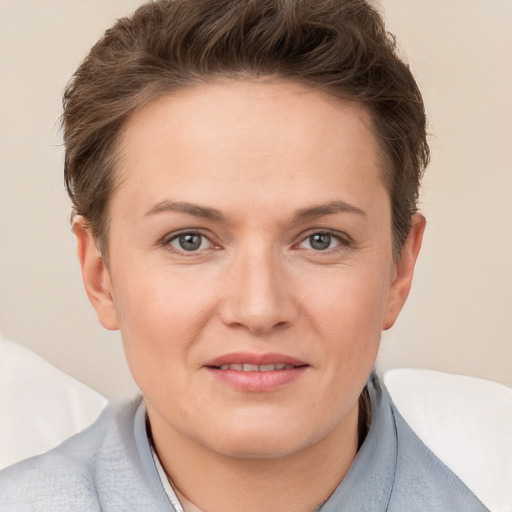 Joyful white adult female with short  brown hair and grey eyes