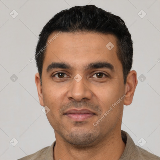 Joyful latino young-adult male with short  black hair and brown eyes