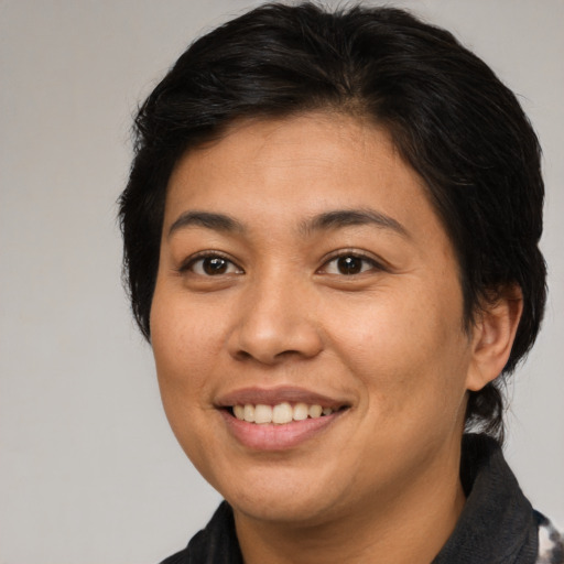 Joyful asian young-adult female with medium  brown hair and brown eyes