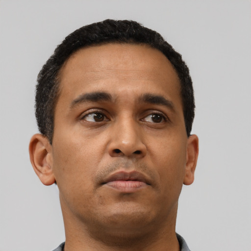 Neutral latino young-adult male with short  brown hair and brown eyes