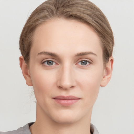 Joyful white young-adult female with short  brown hair and grey eyes