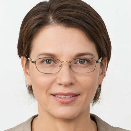 Joyful white adult female with short  brown hair and grey eyes