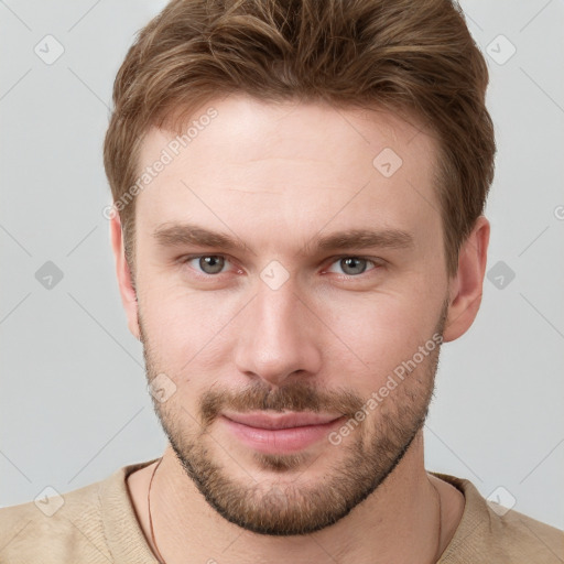 Joyful white young-adult male with short  brown hair and grey eyes