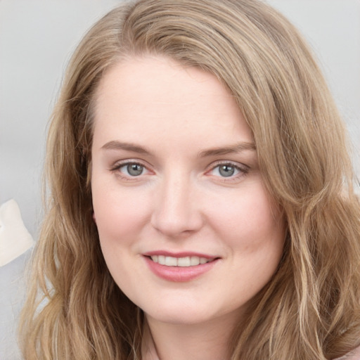 Joyful white young-adult female with long  brown hair and blue eyes