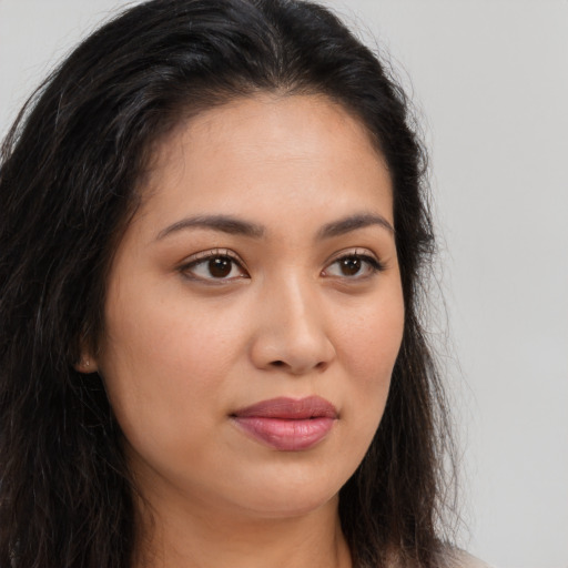 Joyful latino young-adult female with long  brown hair and brown eyes
