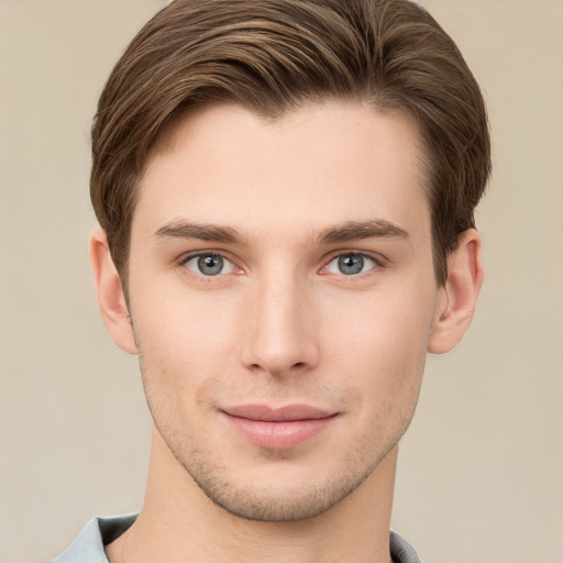 Joyful white young-adult male with short  brown hair and grey eyes