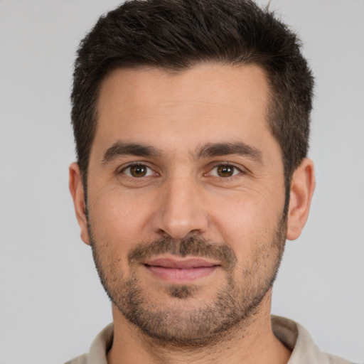 Joyful white young-adult male with short  brown hair and brown eyes