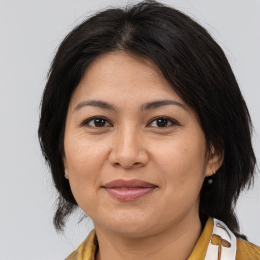 Joyful asian adult female with medium  brown hair and brown eyes