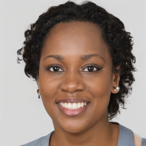 Joyful black young-adult female with medium  black hair and brown eyes
