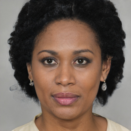 Joyful black adult female with short  brown hair and brown eyes
