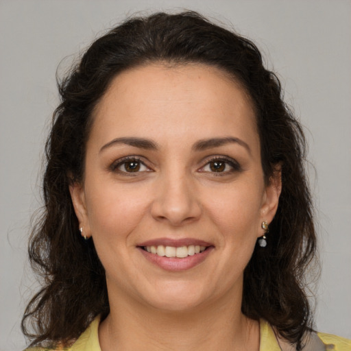 Joyful white adult female with medium  brown hair and brown eyes