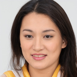 Joyful asian young-adult female with long  brown hair and brown eyes