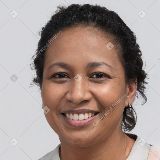 Joyful black adult female with short  brown hair and brown eyes