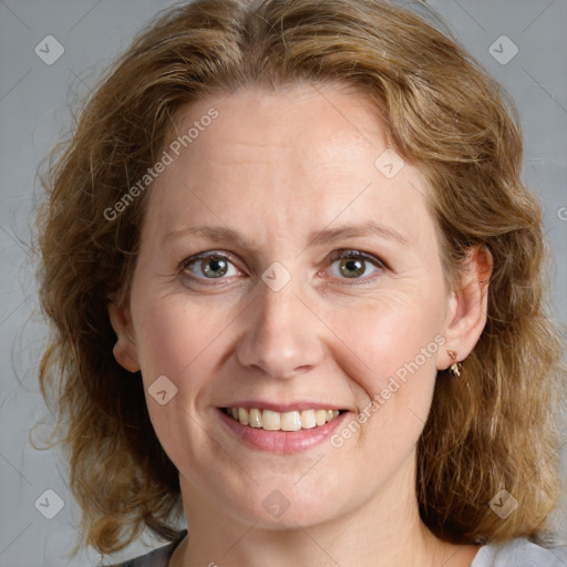 Joyful white adult female with medium  brown hair and blue eyes