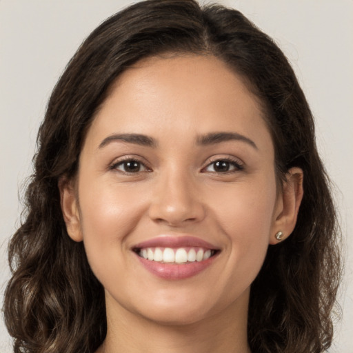 Joyful white young-adult female with long  brown hair and brown eyes