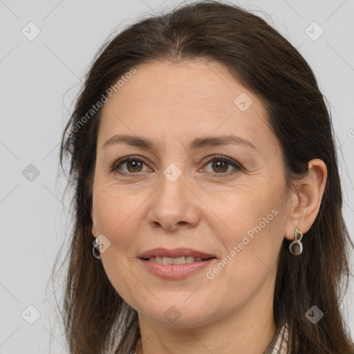 Joyful white adult female with long  brown hair and brown eyes