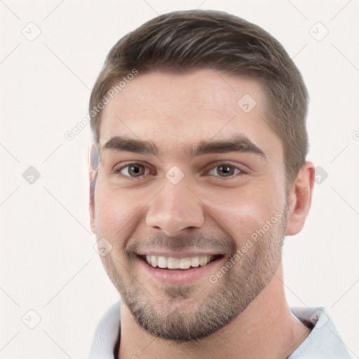 Joyful white young-adult male with short  brown hair and grey eyes