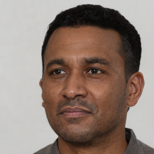Neutral black adult male with short  black hair and brown eyes