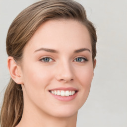 Joyful white young-adult female with long  brown hair and green eyes