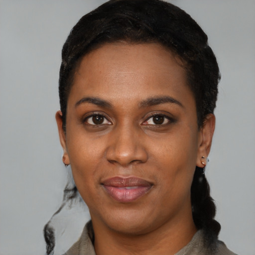 Joyful black young-adult female with short  black hair and brown eyes