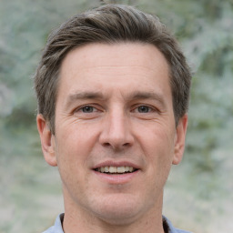 Joyful white adult male with short  brown hair and grey eyes