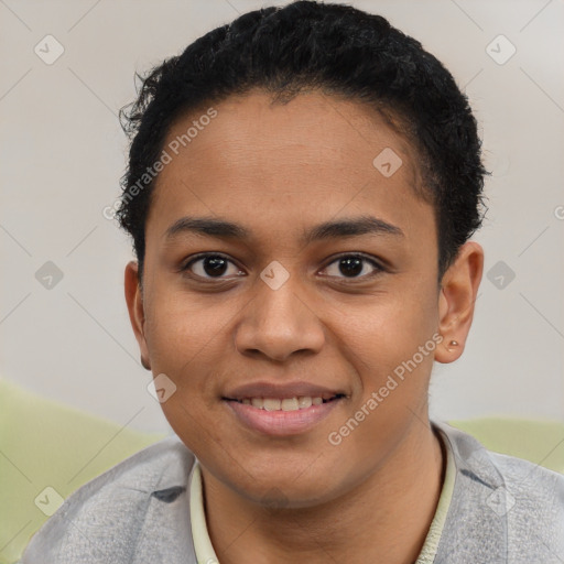 Joyful black young-adult female with short  black hair and brown eyes