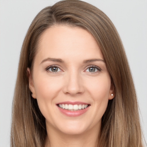 Joyful white young-adult female with long  brown hair and brown eyes