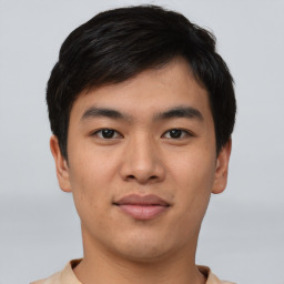 Joyful asian young-adult male with short  black hair and brown eyes