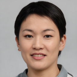 Joyful asian young-adult female with short  black hair and brown eyes