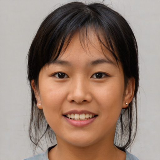 Joyful asian young-adult female with medium  brown hair and brown eyes