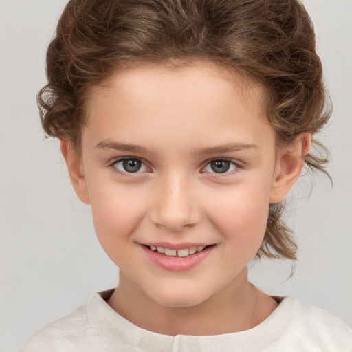 Joyful white child female with medium  brown hair and brown eyes