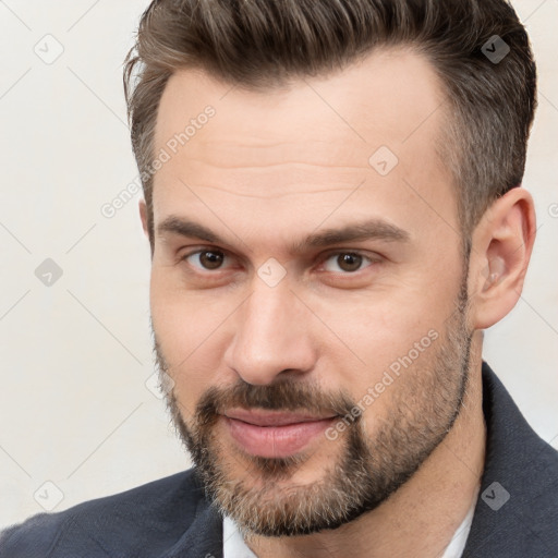 Joyful white adult male with short  brown hair and brown eyes