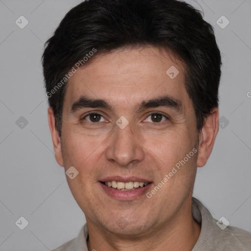 Joyful white adult male with short  brown hair and brown eyes