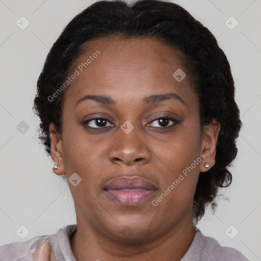 Joyful black adult female with short  brown hair and brown eyes