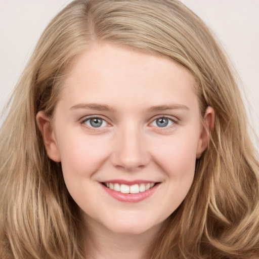 Joyful white young-adult female with long  brown hair and blue eyes