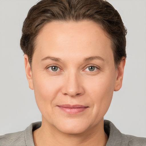 Joyful white adult female with short  brown hair and grey eyes