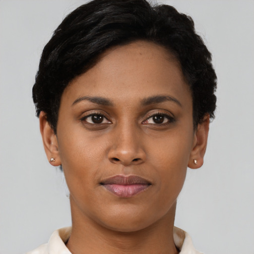 Joyful black young-adult female with short  brown hair and brown eyes