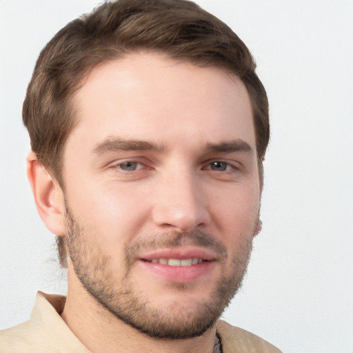 Joyful white young-adult male with short  brown hair and grey eyes