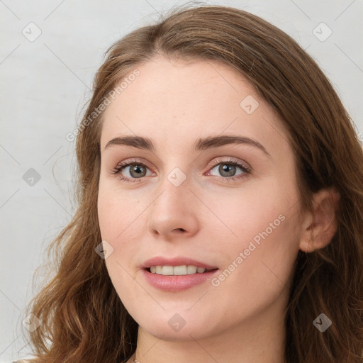 Joyful white young-adult female with long  brown hair and green eyes