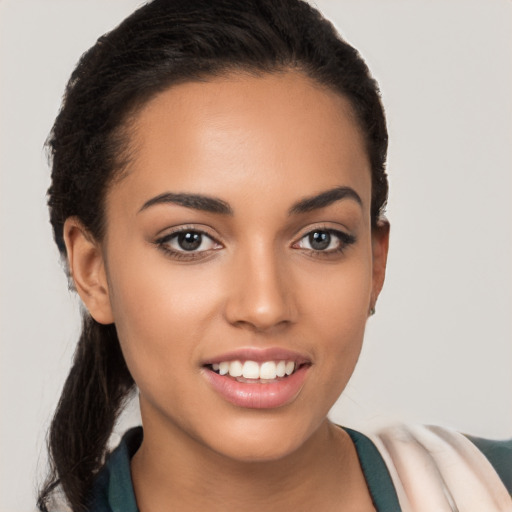 Joyful latino young-adult female with long  brown hair and brown eyes