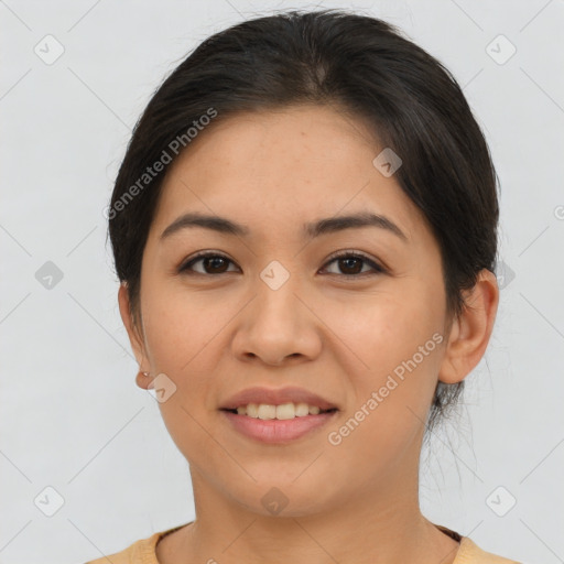 Joyful latino young-adult female with short  brown hair and brown eyes