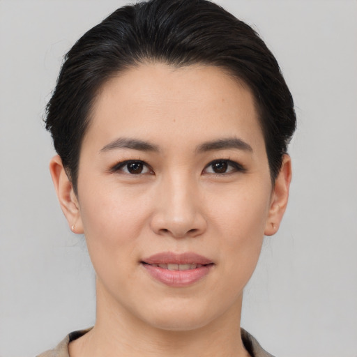 Joyful asian young-adult female with short  brown hair and brown eyes