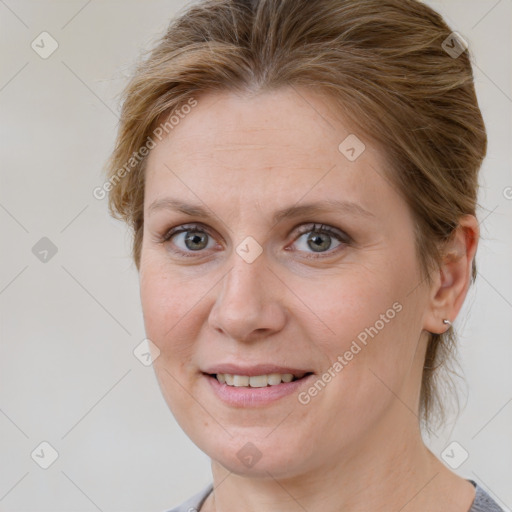 Joyful white adult female with medium  brown hair and grey eyes